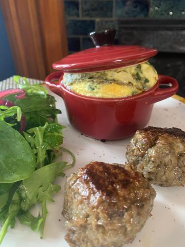 a plate of food with meatballs and a pot of food at Cartier Mansion in Ludington