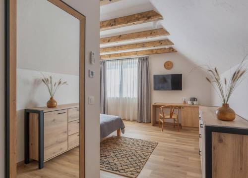 a bedroom with a bed and a desk in a room at Tulipán Ház Gyál in Gyál