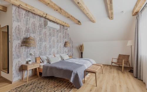 a bedroom with a bed and a stone wall at Tulipán Ház Gyál in Gyál