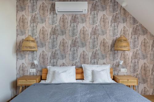 a bedroom with a bed with two night stands at Tulipán Ház Gyál in Gyál