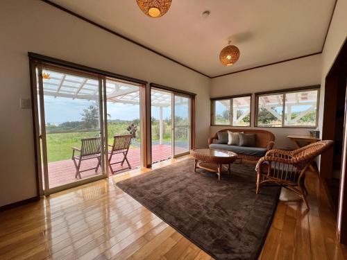a living room with a couch and a table at Ayamarusou - Vacation STAY 78088v in Amami