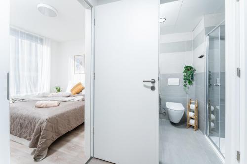 a bedroom with a bed and a glass shower at MyMozart apartments by Rentero property in Prague