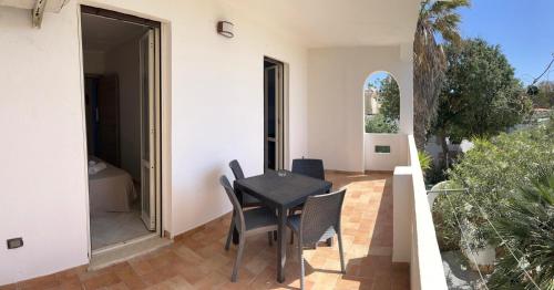 a small black table and chairs on a patio at Villa Dacla in Lampedusa