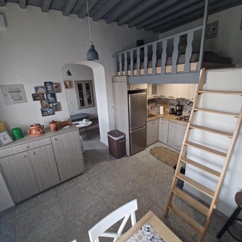 a kitchen with a ladder in the middle of a room at Traditional house in the heart of Naxos in Dhamariónas