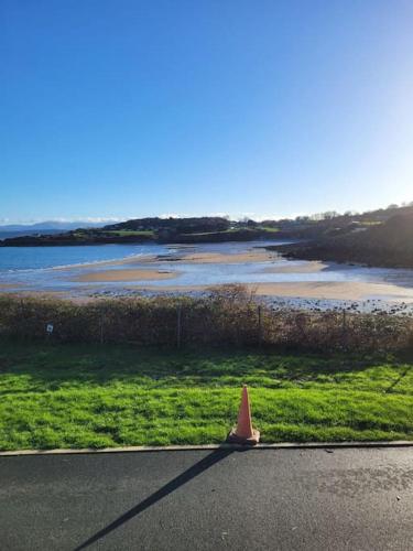 a orange cone sitting on the side of a road at Caravan at Harbour House in Moelfre