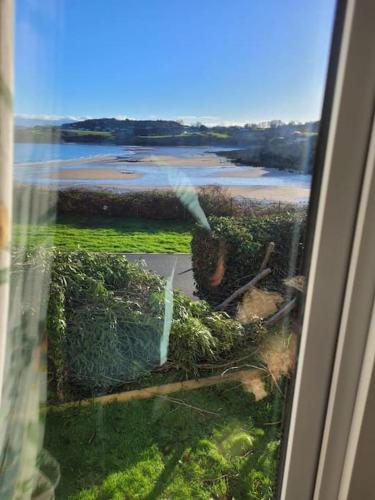 a view of a river from a window at Caravan at Harbour House in Moelfre