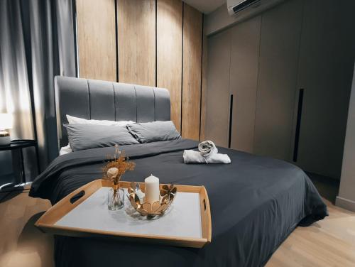 a bedroom with a bed with a tray with a table at Datum Jelatek Residences Royalty Luxury Apartment, Walking Distance To LRT, Gleneagles KL & KLCC in Kampong Datok Keramat
