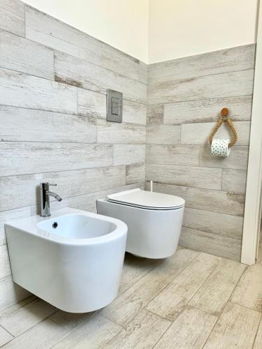 a bathroom with a white toilet and a sink at Bilocale Bellavista in Marettimo