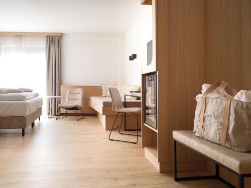 a hotel room with a bed and a living room at Hotel Bütgenbacher Hof in Butgenbach