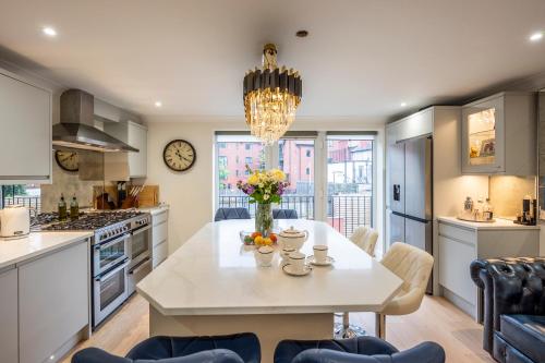 a kitchen with a table with a vase of flowers on it at Exclusive New City Center Designer Mews Home in Chester