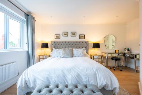 a bedroom with a large white bed and a desk at Exclusive New City Center Designer Mews Home in Chester