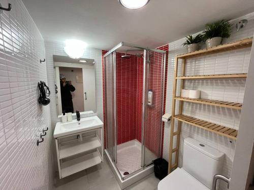 a bathroom with a shower and a toilet and a sink at Centrally Apartment in El Raval in Barcelona