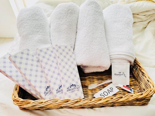 a basket filled with towels and socks on a bed at Tagaytay Staycation - Casa Editha in Tagaytay