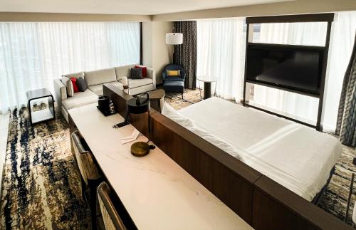a large living room with a couch and a tv at The Landing Hotel at Rivers Casino Pittsburgh in Pittsburgh