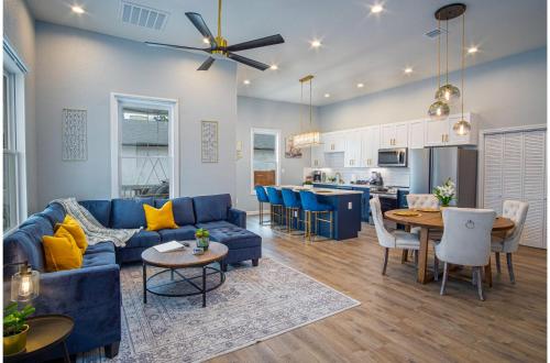 a living room with a blue couch and a table at Trendy Historical Home Near Downtown Attractions in San Antonio