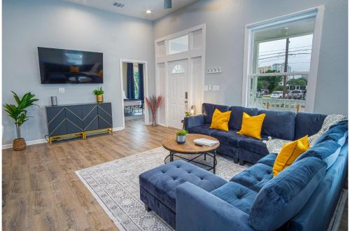 a living room with a blue couch and a table at Trendy Historical Home Near Downtown Attractions in San Antonio