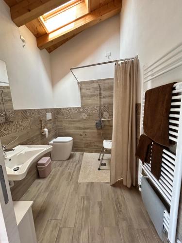 a bathroom with a sink and a toilet and a shower at Locanda B&B Da Nati in Arba