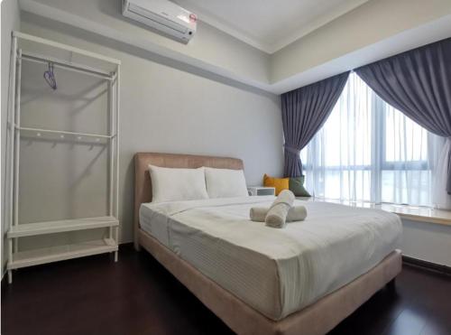 une chambre avec un lit avec un ours en peluche dessus dans l'établissement R&F Princess Cove - JB Causeway - Sauna - Netflix - Hotel Like Facilities, à Johor Bahru