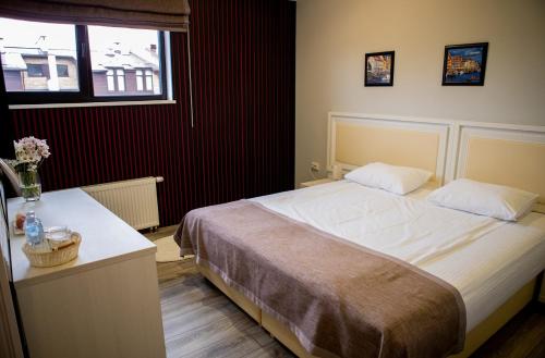 a bedroom with a large bed and a window at Sport Point Hotel in Khimki