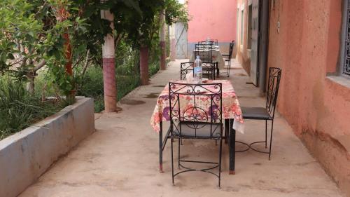 a table and chairs on the side of a street at Riad Bouchra in Tamtetoucht