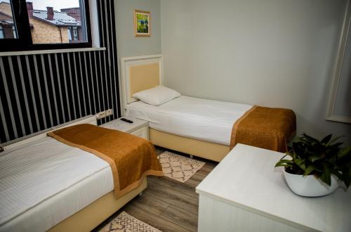 a small room with two beds and a window at Sport Point Hotel in Khimki