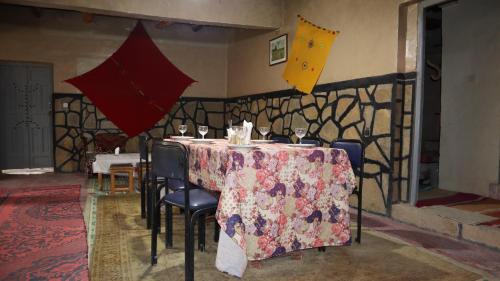 a table with wine glasses and umbrellas on it at Riad Bouchra in Tamtetoucht