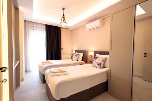 Postel nebo postele na pokoji v ubytování Livia Luxury Apart Hotel