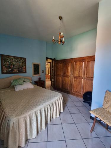 a bedroom with a bed and a chair at Casa Anna Maria in Iglesias