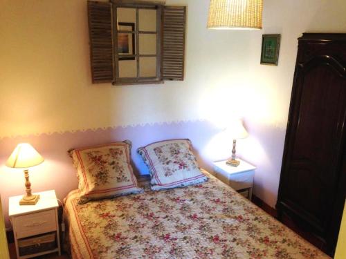 una camera con un letto con due cuscini sopra di Un petit paradis en Provence a Fréjus