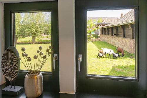 a door with a window with a group of animals outside at Vakantiehuisje in de polder in Oud-Alblas