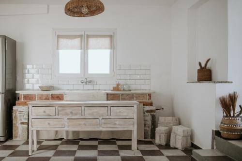 a bathroom with a sink and a window at Yi & Thalassa Living by KHI in Kithnos