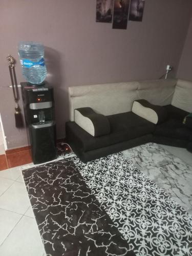a living room with a couch and a rug at شقه in Kafr Abū ʼumaydah