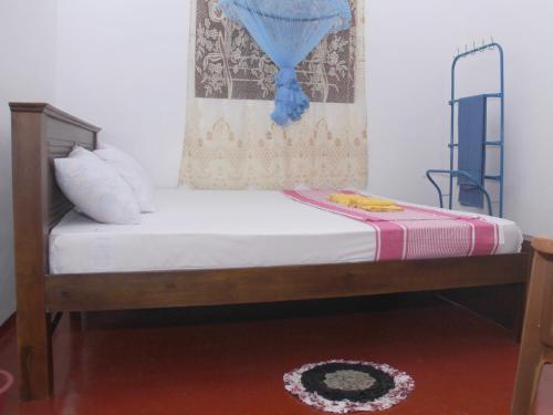 a small bed in a room with at Dilan Guest in Mirissa