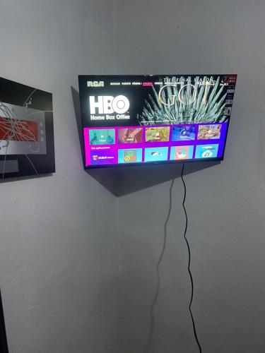 Elle comprend une télévision à écran plat suspendue au mur. dans l'établissement Juju House, à Cap-Haïtien