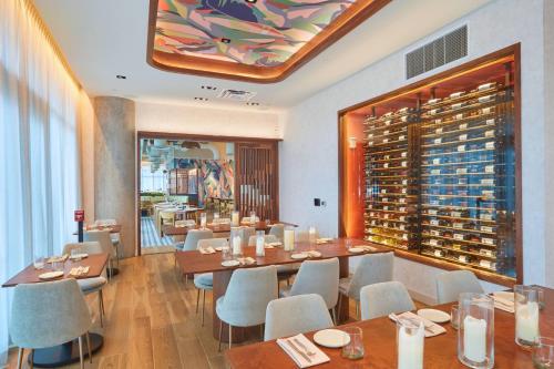 a restaurant with tables and chairs and a wine cellar at Renaissance Honolulu Hotel & Spa in Honolulu