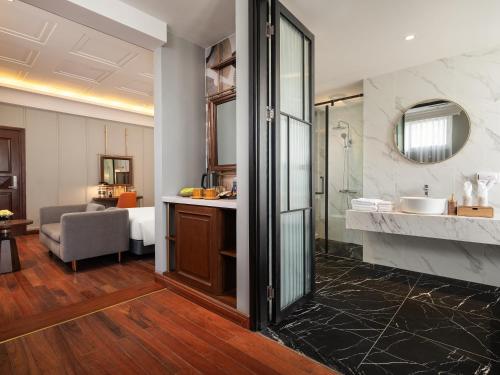 a bathroom with a shower and a sink in a room at Minerva Premium Hotel in Hanoi