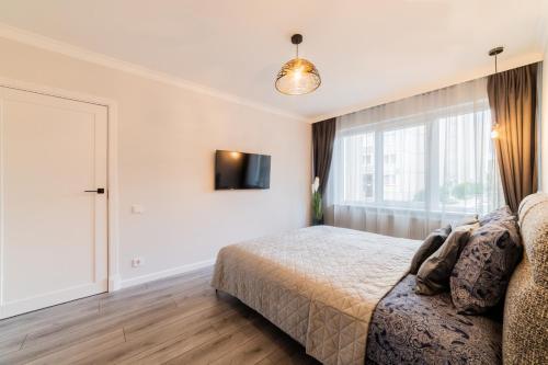 Ένα ή περισσότερα κρεβάτια σε δωμάτιο στο Grey Apartments