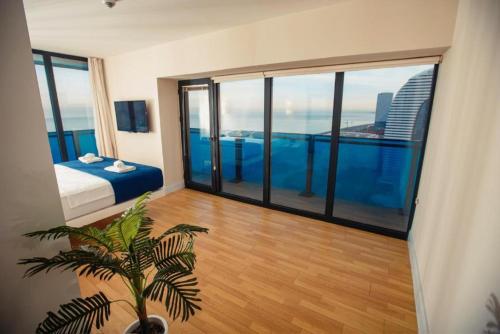a bedroom with a bed and a view of the city at ORBI CITY Beautiful Luxurios Panoramic View on batumi in Batumi
