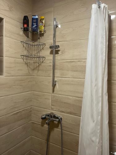 a bathroom with a shower with a shower curtain at Vikendice - Vodenica Jurić in Prozor
