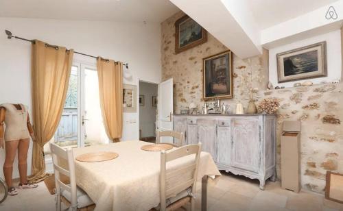 a dining room with a table and chairs in a room at BedandBeige, La Belle Etape in Linas