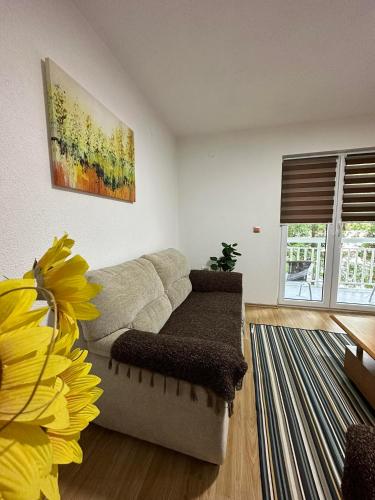 a living room with a couch and a flower at Riverstone Retreat Villa in Jajce