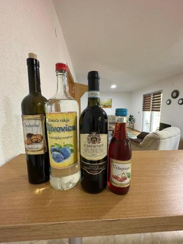 three bottles of wine sitting on top of a table at Riverstone Retreat Villa in Jajce