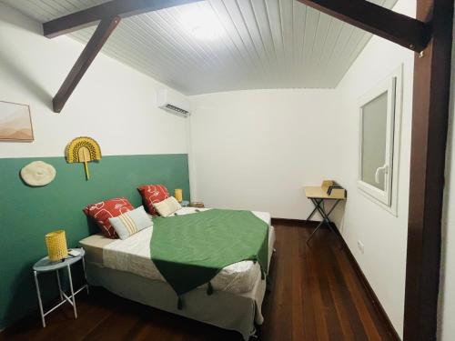a bedroom with a bed and a green and white wall at Bahia Beach- Duplex, plage privée, Netflix in Cayenne