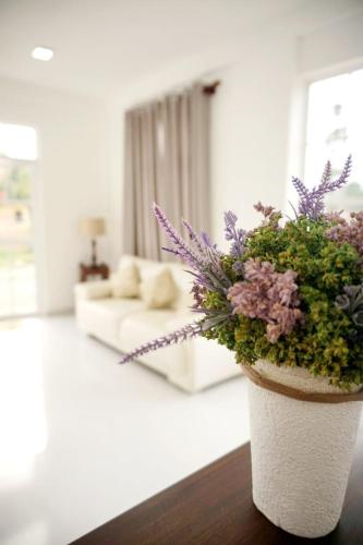 a flower pot sitting on a table in a living room at Ivy Home in Nuwara Eliya