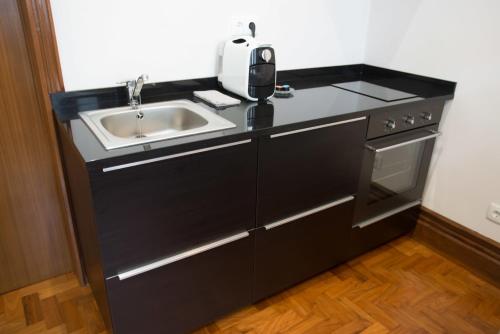 a kitchen with a sink and a counter top at Nidos Accommodation Gaia in Vila Nova de Gaia