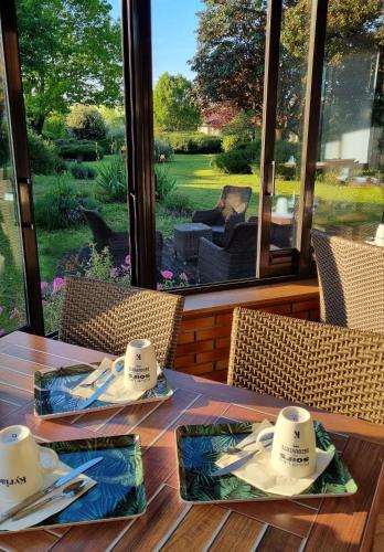 a wooden table with hats on top of it at Kyriad Angoulême Nord Champniers- Hôtel & Résidence in Champniers