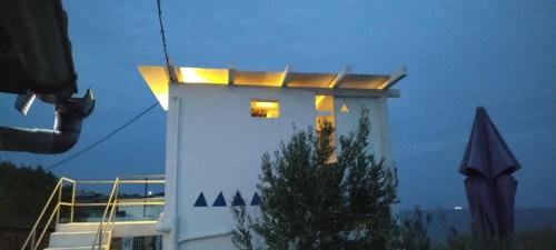 a white building with lights on top of it at Peristeronas in Liaropá