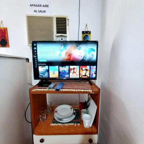 a computer monitor sitting on top of a table at Jasy Hospedaje in Paraguarí