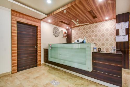 a dressing room with a large window and a door at Super Collection O 75732 Hotel Aatithya in Bhubaneshwar