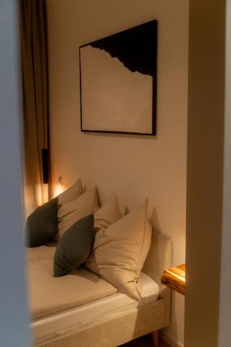 a couch with pillows on it in a room at Modernes Altstadt Apartment in Bad Belzig
